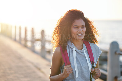 Buy stock photo Girl, thinking and student at beach on spring break, smile and explore with sunset on promenade. College person, sightseeing vision or term holiday with bag at coastline, travel and view in Miami