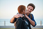 Attractive young man embracing african american girlfriend happy couple enjoying relationship smiling on seaside
