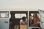 Two friends hanging out in vintage camper van on road trip adventure travel