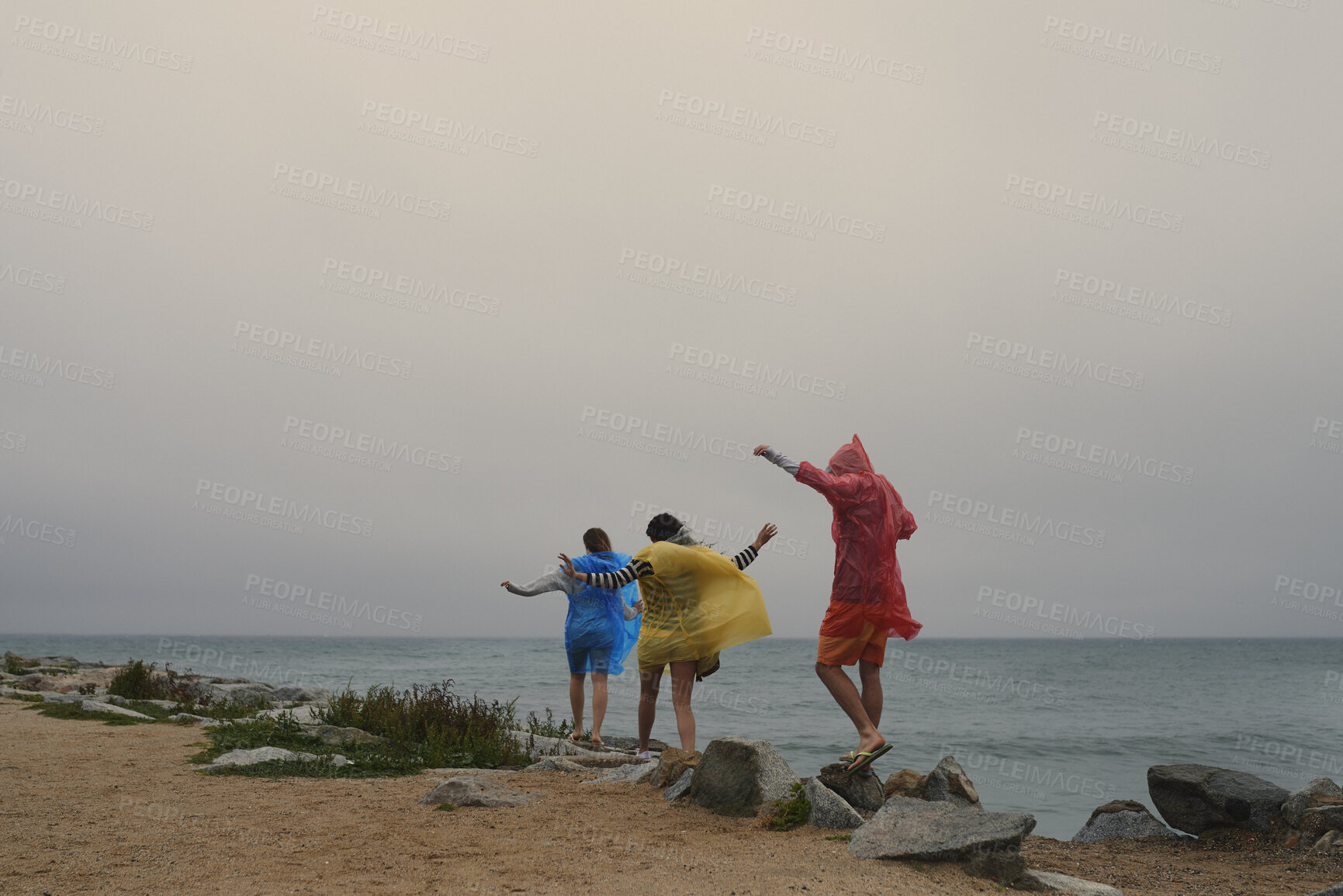 Buy stock photo Back, walking and group of friends by beach in winter on holiday, getaway or weekend trip together. Adventure, outdoor and people by ocean on vacation for bonding, connection or fun in cold weather.