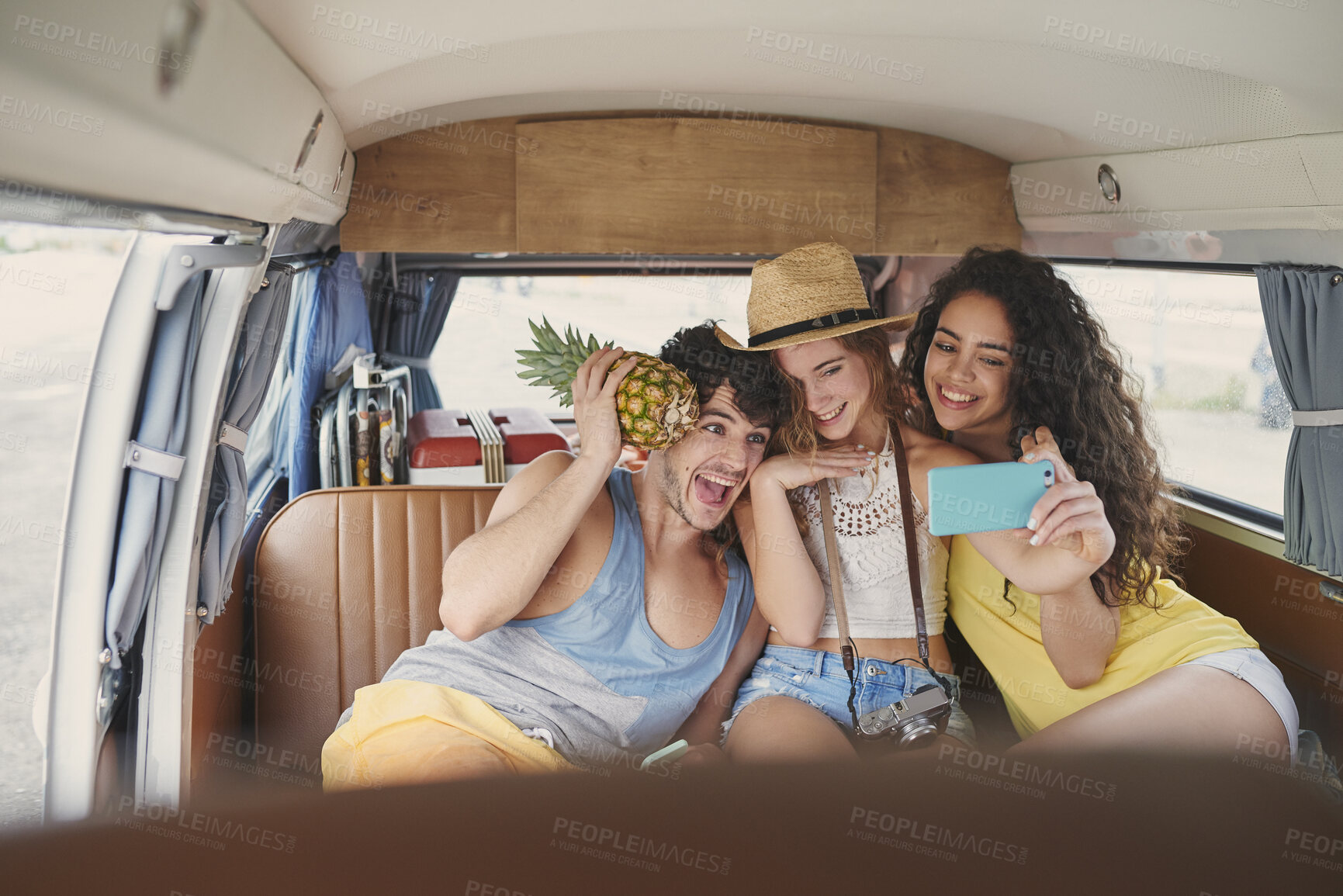 Buy stock photo Silly, selfie and friends in camper van for memories on road trip, adventure and vacation together. Happy, fruit and man with women in vehicle with picture for tourism, holiday and social media