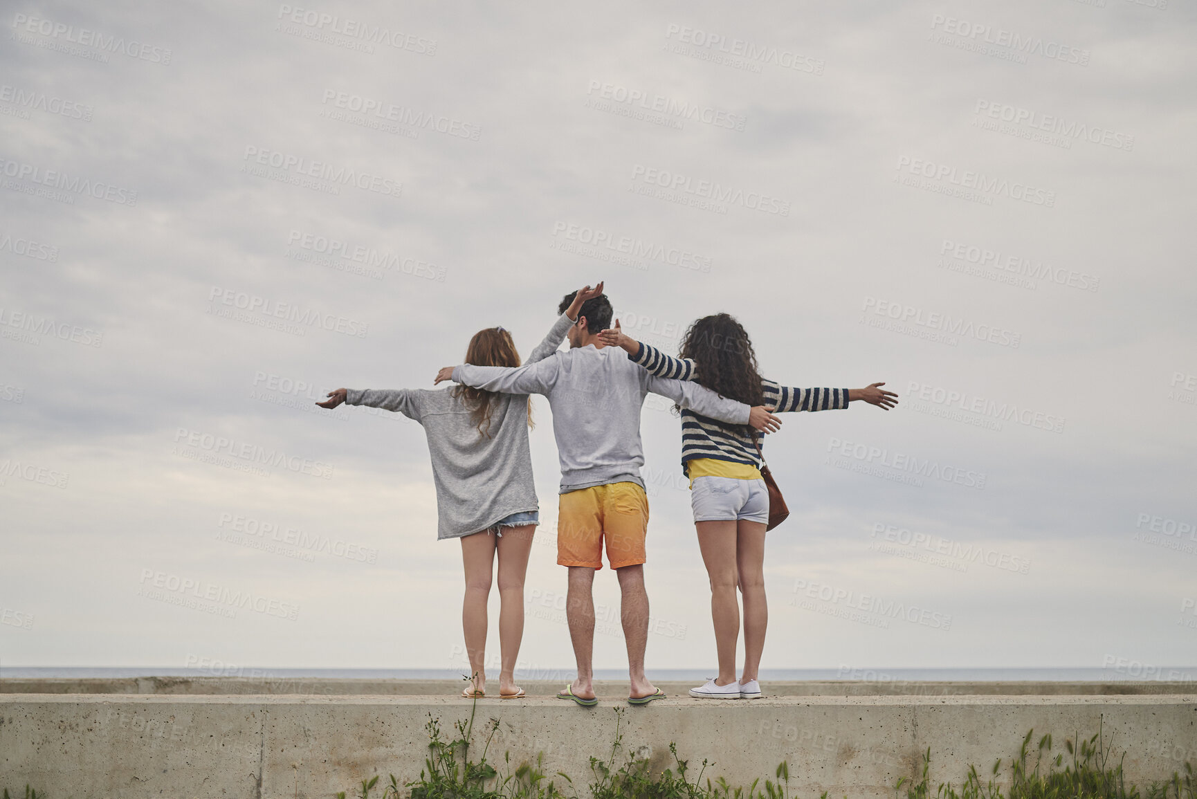 Buy stock photo Back, hug and group of friends by beach in winter on holiday, getaway or weekend trip together. Space, outdoor and people by ocean on seaside vacation for bonding, connection or fun in cold weather.