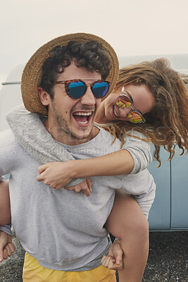 Buy stock photo Couple, happy and piggy back with car for road trip with sunglasses, embrace and connection on vacation. People, partner and relationship on summer getaway, playful and hug with vehicle on holiday