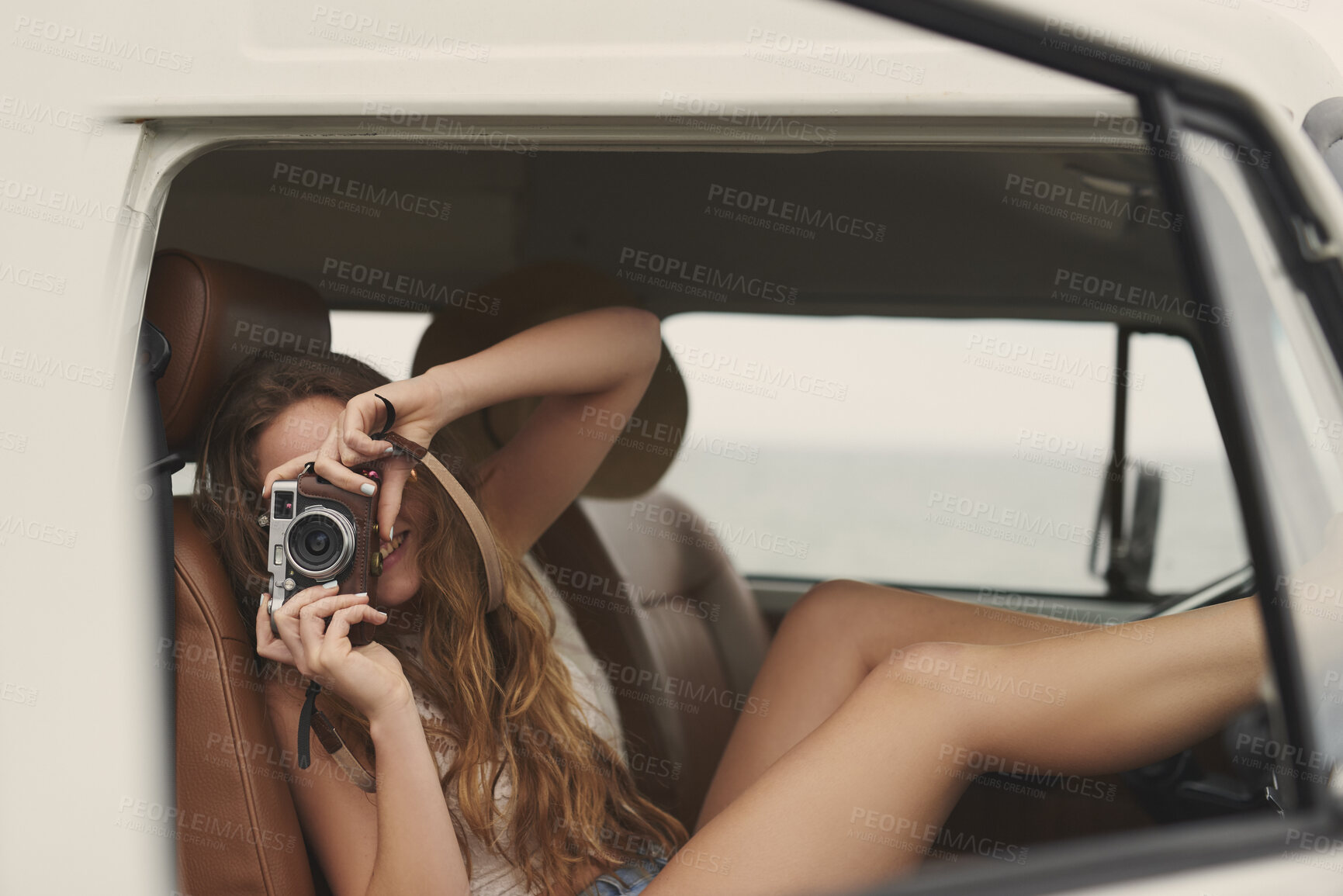 Buy stock photo Happy, camera and woman in van for travel memories on road trip, adventure and vacation in nature. Smile, sightseeing and person in vehicle with photograph for tourism, holiday and journey outdoor