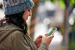 young woman using smartphone texting browsing online social media reading sms messages on mobile phone technology in city street