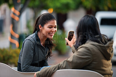 Buy stock photo Women, friends and share with phone at park in city with smile, funny video and relax in summer. People, happy and show with mobile app, gossip or laugh with post on social network in urban town