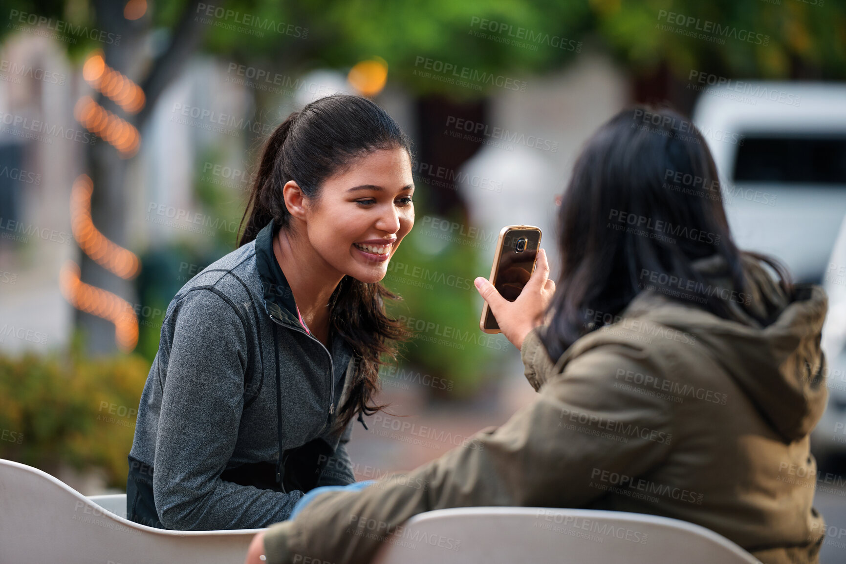 Buy stock photo Women, friends and share with phone at park in city with smile, funny video and relax in summer. People, happy and show with mobile app, gossip or laugh with post on social network in urban town