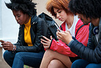 group of friends using smartphones texting sitting outdoors students browsing social media on mobile phones