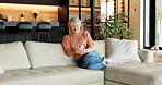 Senior, relax or happy woman with phone on sofa for online browsing, entertainment or social media. Elderly, female person or chilling with smile on smartphone for news or network connection in house
