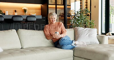Buy stock photo Senior, relax or happy woman with phone on sofa for online browsing, entertainment or social media. Elderly, female person or chilling with smile on smartphone for news or network connection in house