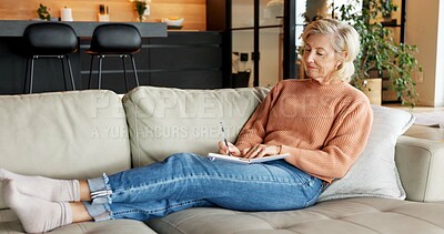 Buy stock photo Notebook, writing and senior woman on sofa with reminder, ideas and planning day in living room. Morning, retirement and elderly person with pen for journalling, diary entry and inspiration in home