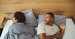 Sleeping, annoyed and above of couple in bed with blanket for resting, dreaming and asleep in morning. Marriage, house and frustrated man with woman with duvet for cold, open and sleepless in bedroom