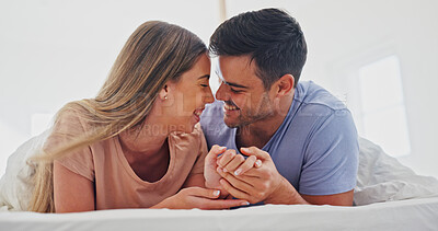 Buy stock photo Holding hands, love and relax with couple in bedroom of home for bonding, support and connection. Trust, romantic partner and happiness with man and woman in bed in house for care and loyalty 