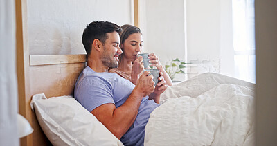 Buy stock photo Love, coffee and smile with couple in bedroom of home for connection, morning and support. Commitment, drinking tea and relax with man and woman in bed in apartment for partner, trust and care