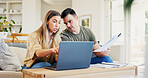 Laptop, documents and couple on sofa in home for discussion on monthly budget for finance planning. Computer, paperwork and man with woman in conversation for paying bills, mortgage or debt in house.