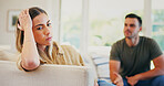 Stress, fighting and woman on sofa in home for conflict, breakup or cheating problem in marriage. Upset, couple and female person in living room with argument, divorce or toxic relationship in house.