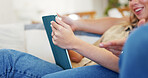Tablet, hands and relax with couple on sofa in home for streaming service, bonding and film app. Movie subscription, love and series platform with man and woman in living room for entertainment