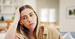 Sad, thinking and woman in home with anxiety for loneliness, broken heart or mental health challenge. Living room, deep thoughts and person with depression, stress and trauma with regret on sofa