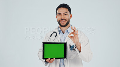 Buy stock photo Doctor, tablet and portrait with OK sign for green screen, Telehealth app or mockup in studio. Man, healthcare worker or smile on space with emoji, technology or advertising on a white background