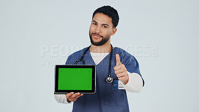 Buy stock photo Nurse, portrait and tablet with thumbs up in studio for advertising, green screen or Telehealth. Man, healthcare worker or like emoji with technology mockup for marketing app on a white background