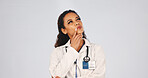 Doctor, woman and thinking in studio with decision, brainstorming and insight for medical diagnosis. Space, person and healthcare worker with problem solving, plan or inspiration on white background.