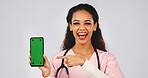 Phone, pointing and nurse in studio with green screen, medical info and announcement with space. Happy, portrait and woman on cellphone for telehealth, website and healthcare news on white background