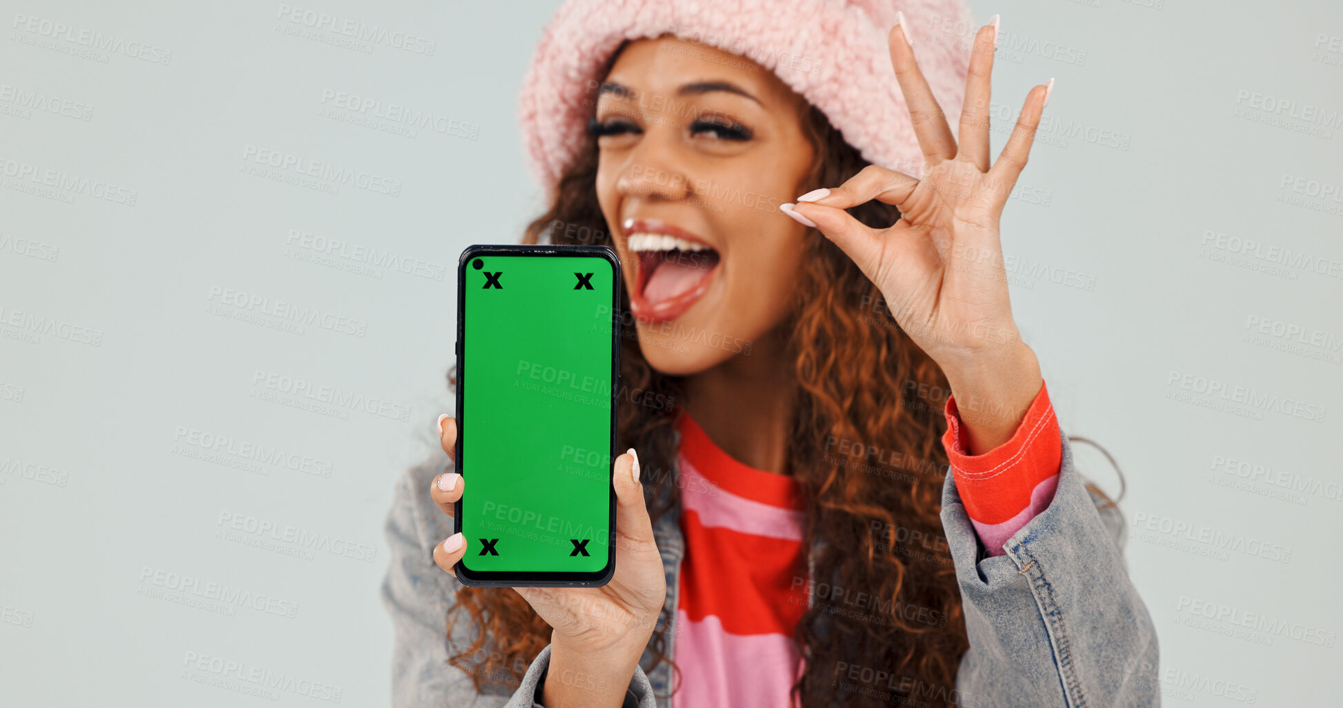 Buy stock photo Wink, promotion and woman with phone, green screen and okay sign for discount or marketing in studio. White background, mockup space and happy person with mobile display, portrait and hand gesture