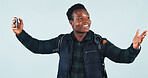 Student, black man or video call with phone in studio for education vlog, social media or smile. Virtual chat, college and happy person on mobile for live streaming, presentation or blue background