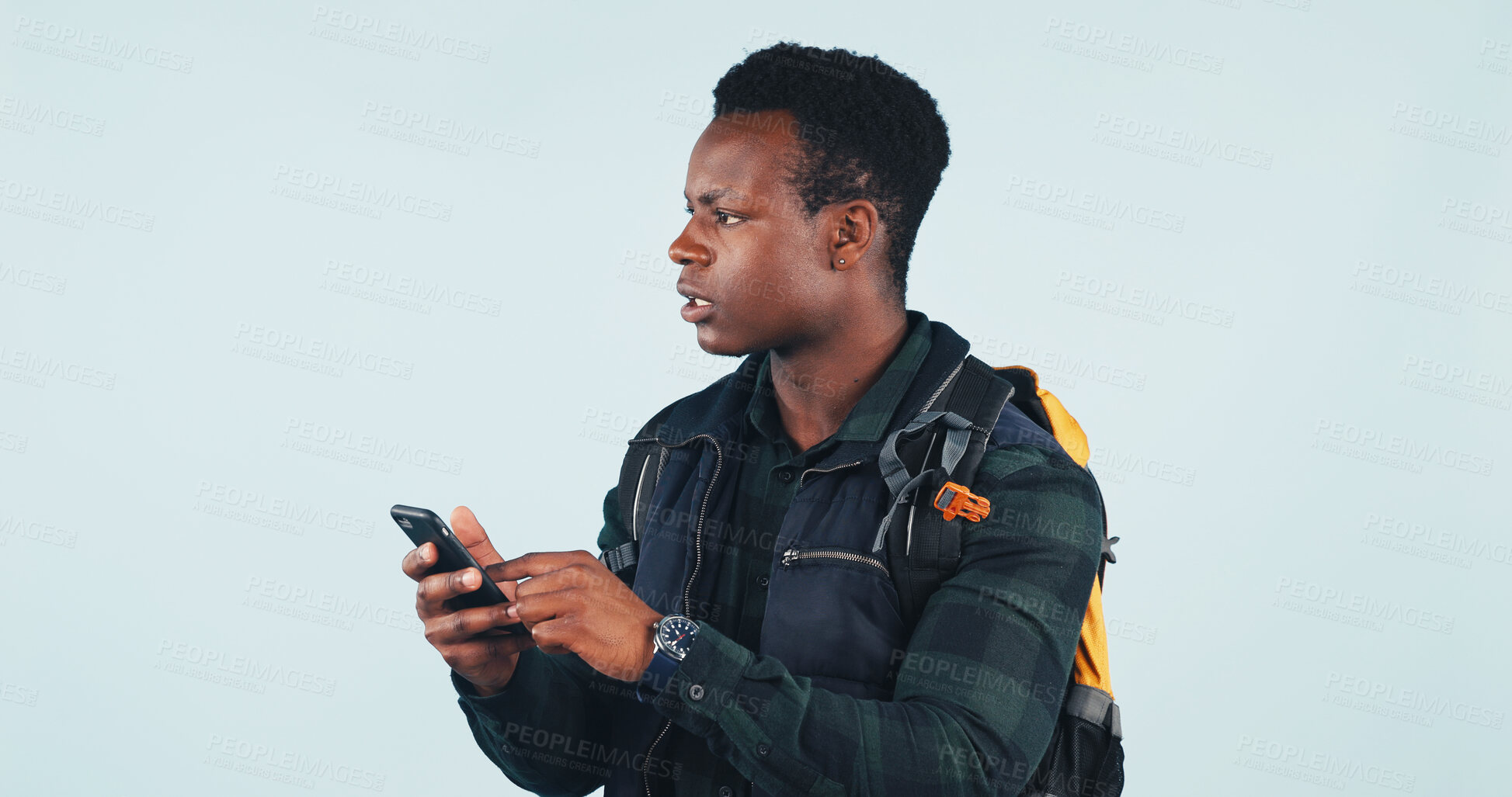 Buy stock photo Lost, map or hiker in studio with phone, no signal or confusion at online compass. Digital, searching or black man on white background with tech, poor reception or wrong directions in trekking hobby.