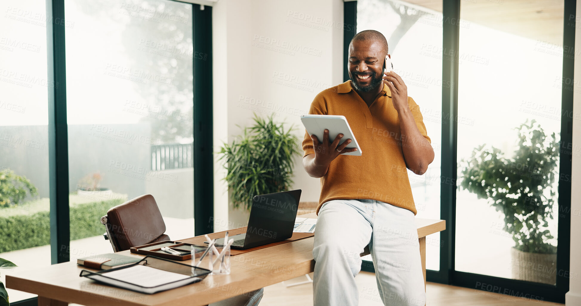 Buy stock photo Man, tablet and phone call in home office with remote work, smile and good news for marketing project. Freelancer, black person and contact in apartment with tech, feedback and happy for ad campaign.