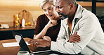 Mature, couple and conversation in home with laptop, online website and review insurance premium. People, interracial marriage and talk in house with computer, reading policy terms and conditions.