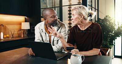 Buy stock photo Mature, couple and credit card in home with laptop, discussion and online payment of utility bills. People, interracial marriage and talk by table with computer, digital banking and household cost.