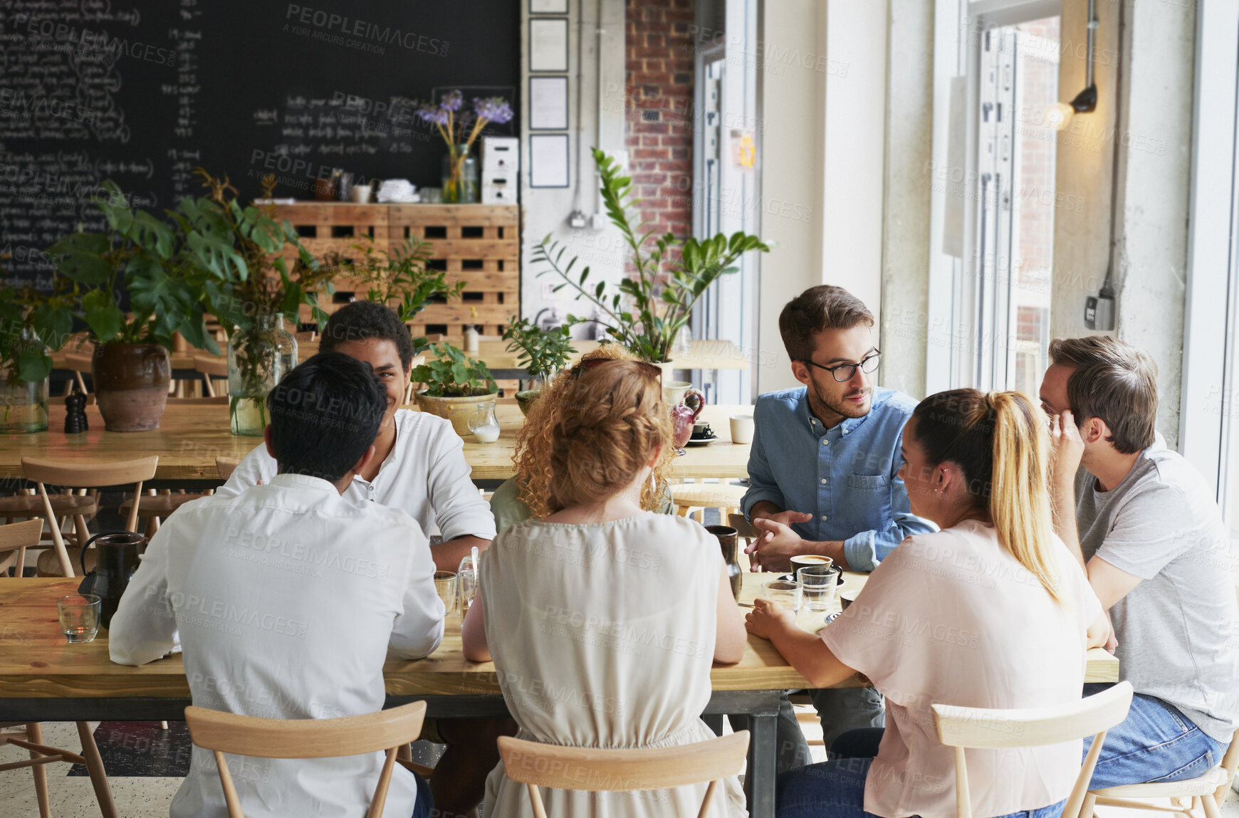 Buy stock photo Creative, people and meeting in cafe with remote work, brainstorming and discussion for advertising. Freelancer, team collaboration and talk in coffee shop with marketing project, planning or update.