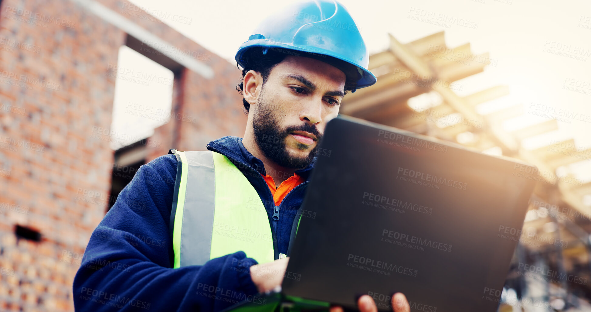 Buy stock photo Laptop, man and typing on construction site with communication for building, renovation or repairs. Safety, feedback and civil engineer with digital tech for inspection update or risk assessment
