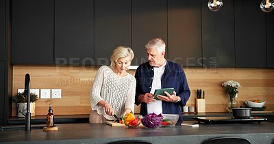 Buy stock photo Couple, tablet and vegetables in home for cooking, tutorial and meal prep for healthy food. Mature people, digital and cutting at house with organic ingredients, culinary skills and recipe for salad