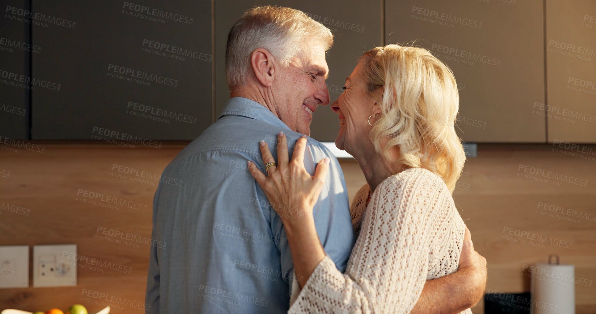 Buy stock photo Love, hug and old couple in home for support, comfort or bonding together in kitchen. Smile, commitment and elderly man with woman for connection with marriage, anniversary and embrace in apartment