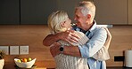Smile, hug and senior couple in home for support, comfort or bonding together in kitchen. Love, commitment and elderly people for connection with marriage, anniversary and embrace in apartment