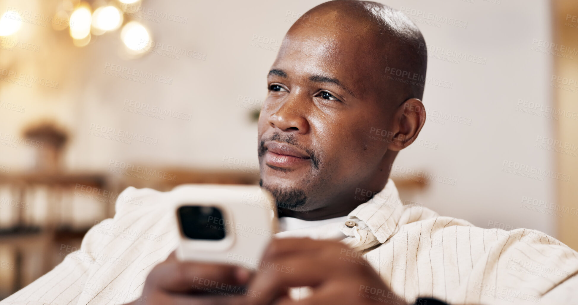 Buy stock photo Man, relax and thinking in living room with phone, browsing or reflection for text message response. Bokeh, black person and vision in home with tech, online dating chat and social media notification