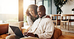 Couple, talk and planning in house with laptop, research together or website for booking holiday. Married, African people and typing on sofa with computer, discussion or purchase flight ticket online
