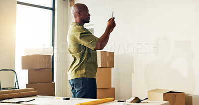 Buy stock photo Man, renovation and picture in new home with tablet, app and digital render for interior design plan. Black person, tech and photography in house with space, website and online tools for remodeling.