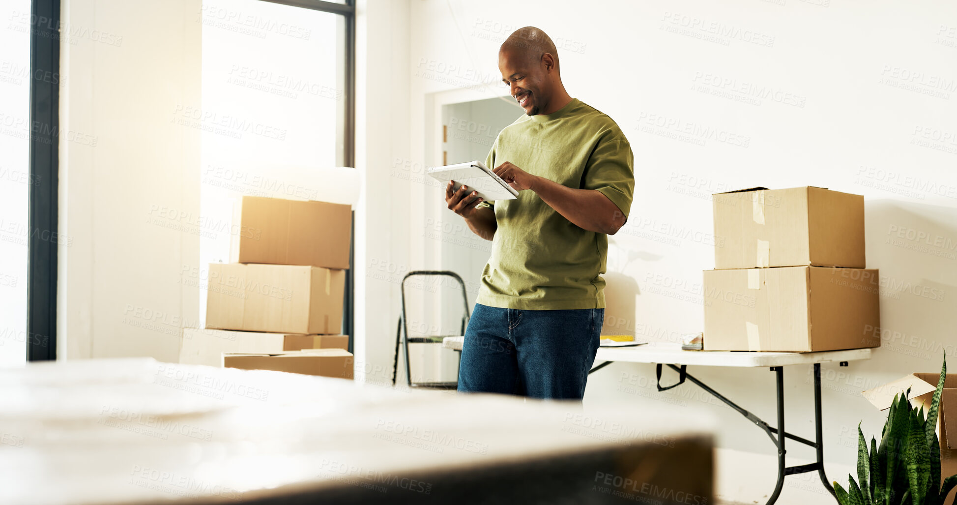 Buy stock photo Man, research and moving in new house with tablet, check interior design trends and renovation idea. Black person, browsing and planning in home with tech, remodeling project and property investment.