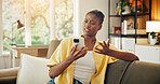 Confused, reading and black woman in house with phone, unclear chat or surprise headline in online news. Digital, what or person with tech, questioning message or shocking info in internet search.