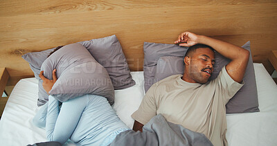 Buy stock photo Snore, couple and woman with pillow in bed for disturbance, noise and annoyed for sleep apnea. Home, above and people cover ears in bedroom with frustrated, upset and irritated for sleepless night