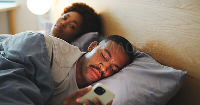 Buy stock photo Phone, couple and man in bedroom with addiction, jealous woman and browsing social media. Ignore, mobile and African people in bed at home with attention problem, relationship neglect or text message