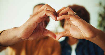 Buy stock photo Love, gesture or couple in house with heart hands, commitment or bonding together in romantic moment. Emoji, loyalty or people with support symbol, partner trust or connection in healthy relationship