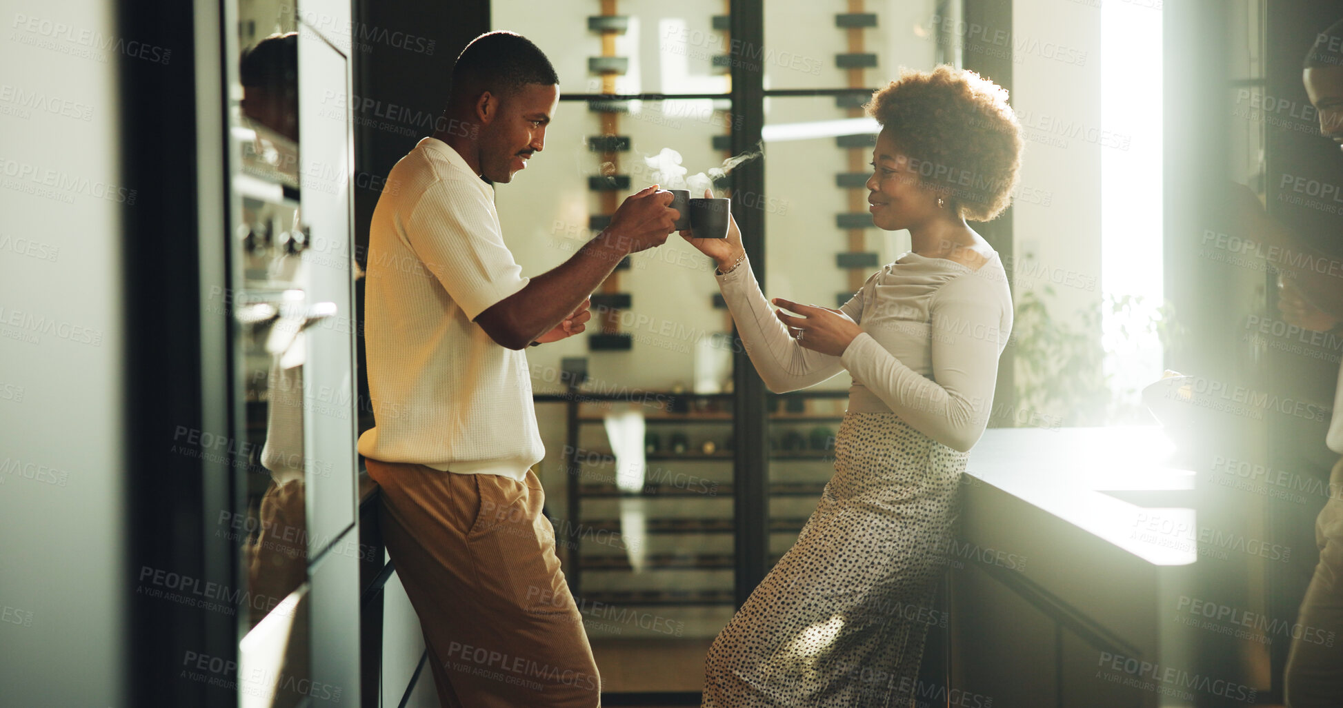 Buy stock photo Morning, coffee and couple in kitchen with cheers, bonding together or love for relationship commitment. Married, black people and toast in home with warm drink, care and connection on weekend break.
