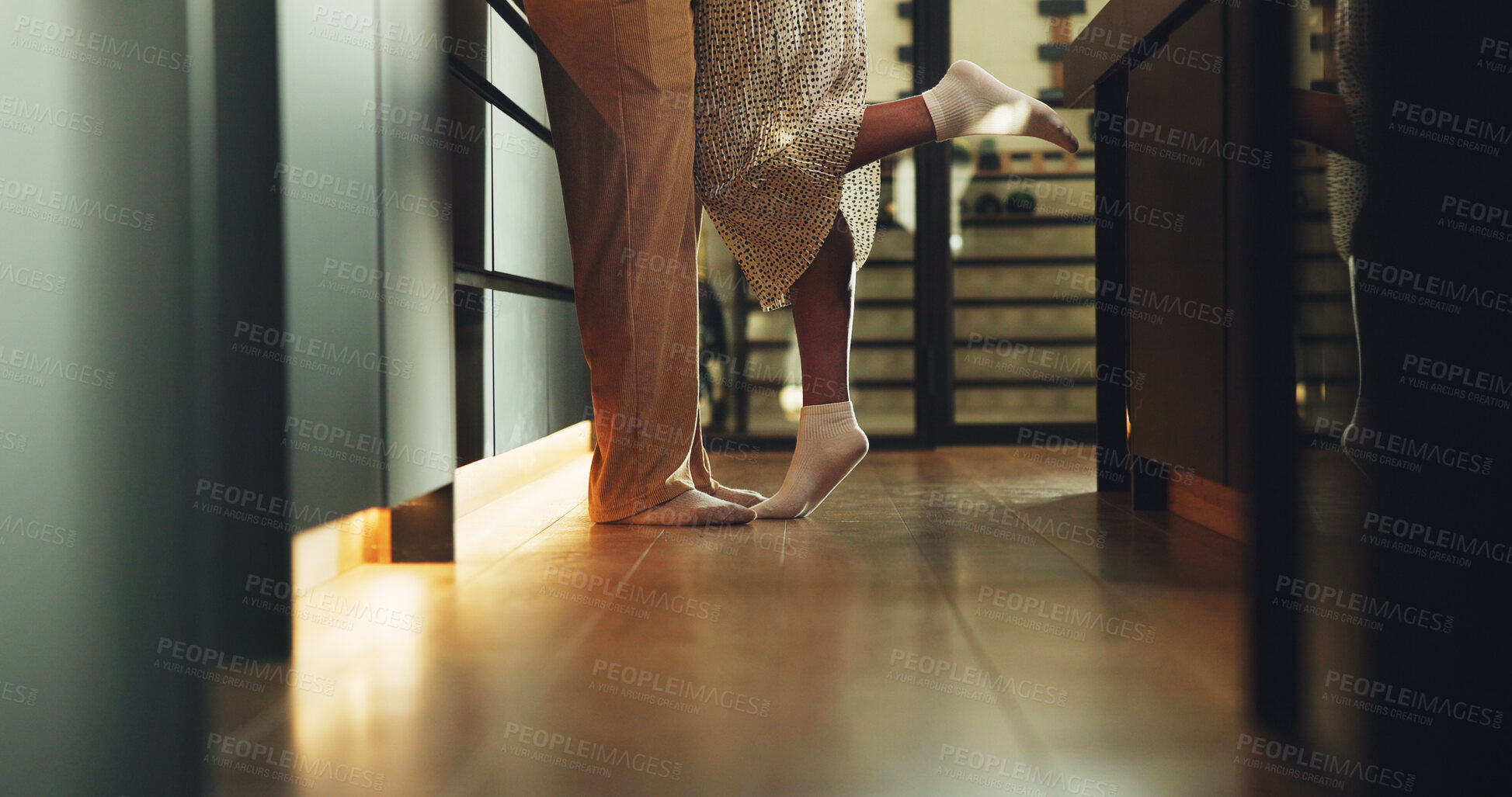 Buy stock photo Couple, legs and romance in home, tiptoe and bonding with partner on weekend, connection and support. People, together and commitment for relationship, feet and affection for spouse or love in house