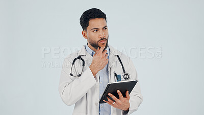 Buy stock photo Doctor, man and thinking with tablet in studio for healthcare or mockup space on a white background. Thoughtful, male person or health worker with technology or idea for medical solution or research