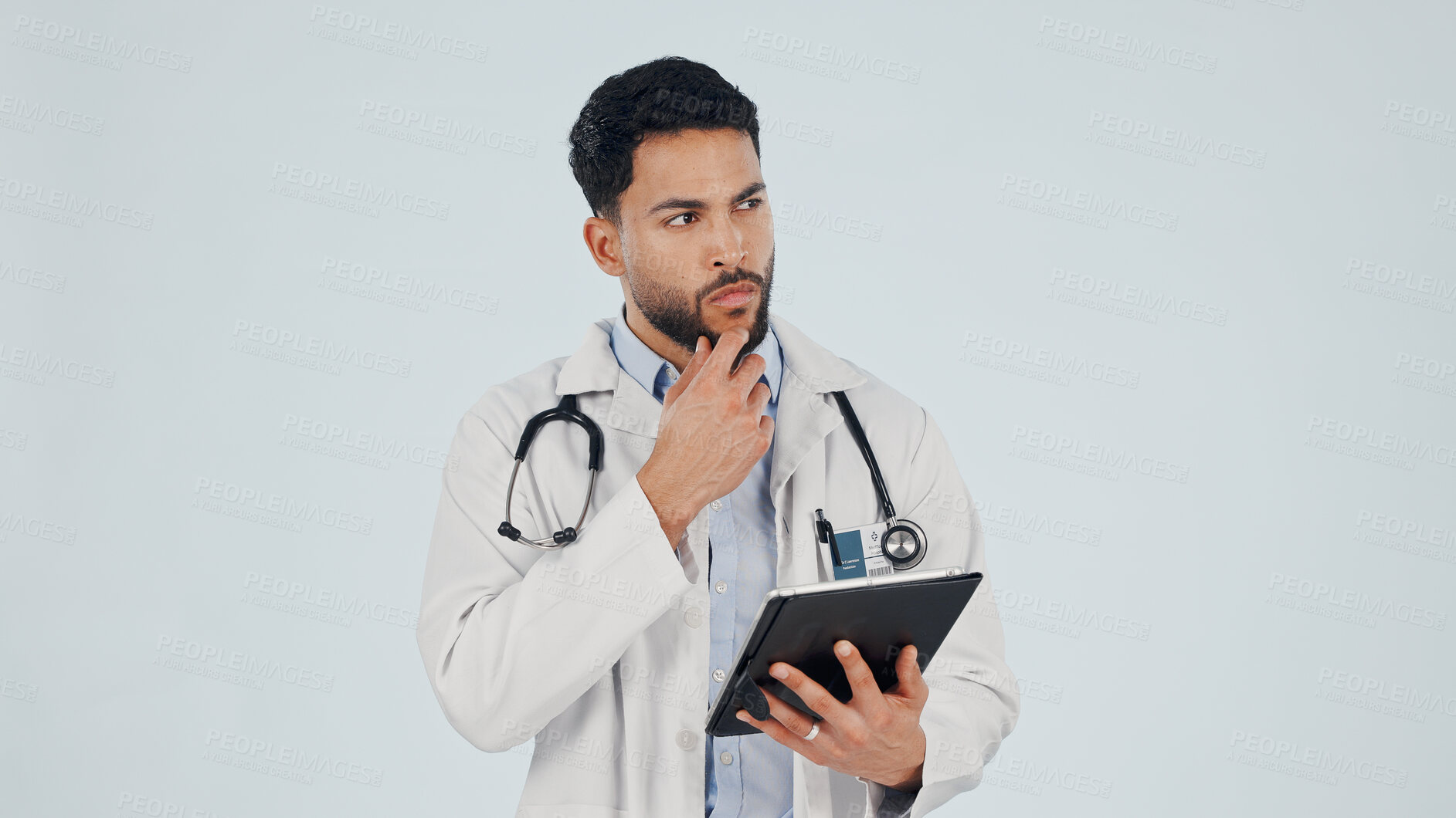 Buy stock photo Doctor, man and thinking with tablet in studio for healthcare or mockup space on a white background. Thoughtful, male person or health worker with technology or idea for medical solution or research
