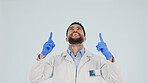 Doctor, studio and pointing up with happy man for advertising or marketing on a white background. Male person, healthcare worker or smile with option, selection or choice for marketing on space